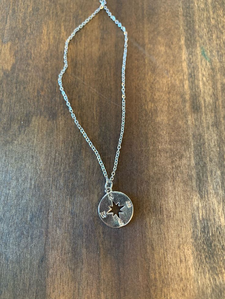 "we think that our small compass necklace is pointing you in the right direction! what a perfect little pendant necklace to add to your collection! we know you will just fall in love! -1 small compass necklace (stainless steel) in gold or silver *PLEASE LET US KNOW WHAT YOU WOULD LIKE AT CHECKOUT* the stainless steel chain is 16\" with a 2\" extension. we are happing to make is shorter or longer. Just let us know at checkout. FYI a choker length would be 15\". every piece of jewelry is handcraft Sterling Silver Compass Necklace For Travel, Sterling Silver Compass Design Necklace For Travel, Compass Design Round Necklace, Metal Compass Design Round Necklace, Travel Stainless Steel Silver Necklaces, Travel Silver Stainless Steel Jewelry, Minimalist Compass Design Round Pendant Necklace, Stainless Steel Pendant Necklace With Compass Design, Gift Compass Design Stainless Steel Necklace