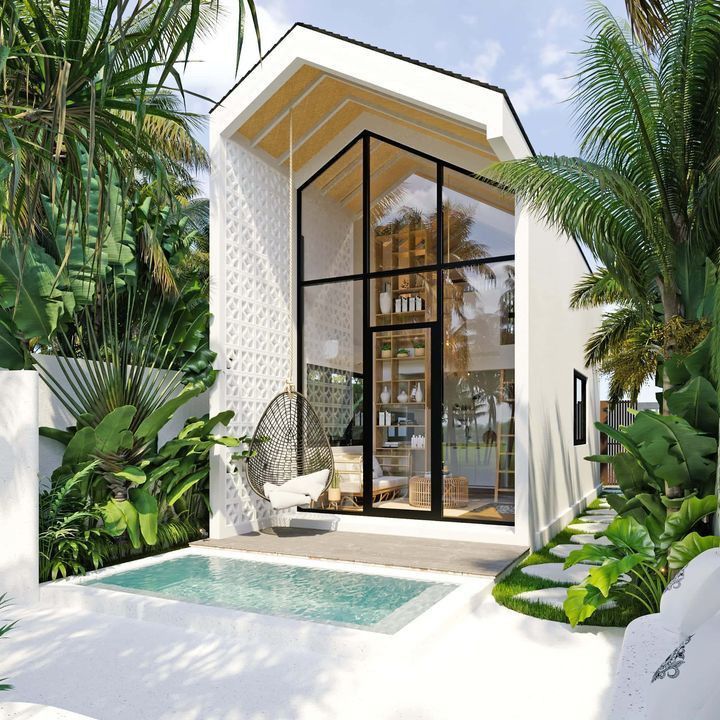 a small white house with a pool in the middle and palm trees around it,