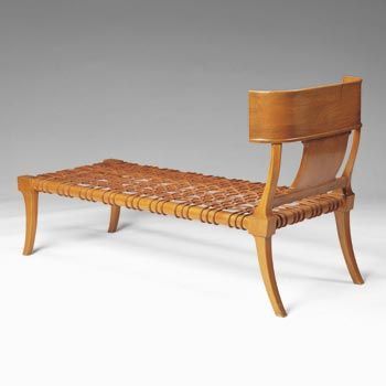 a wooden bench with a woven seat and back rest on the bottom, against a white background