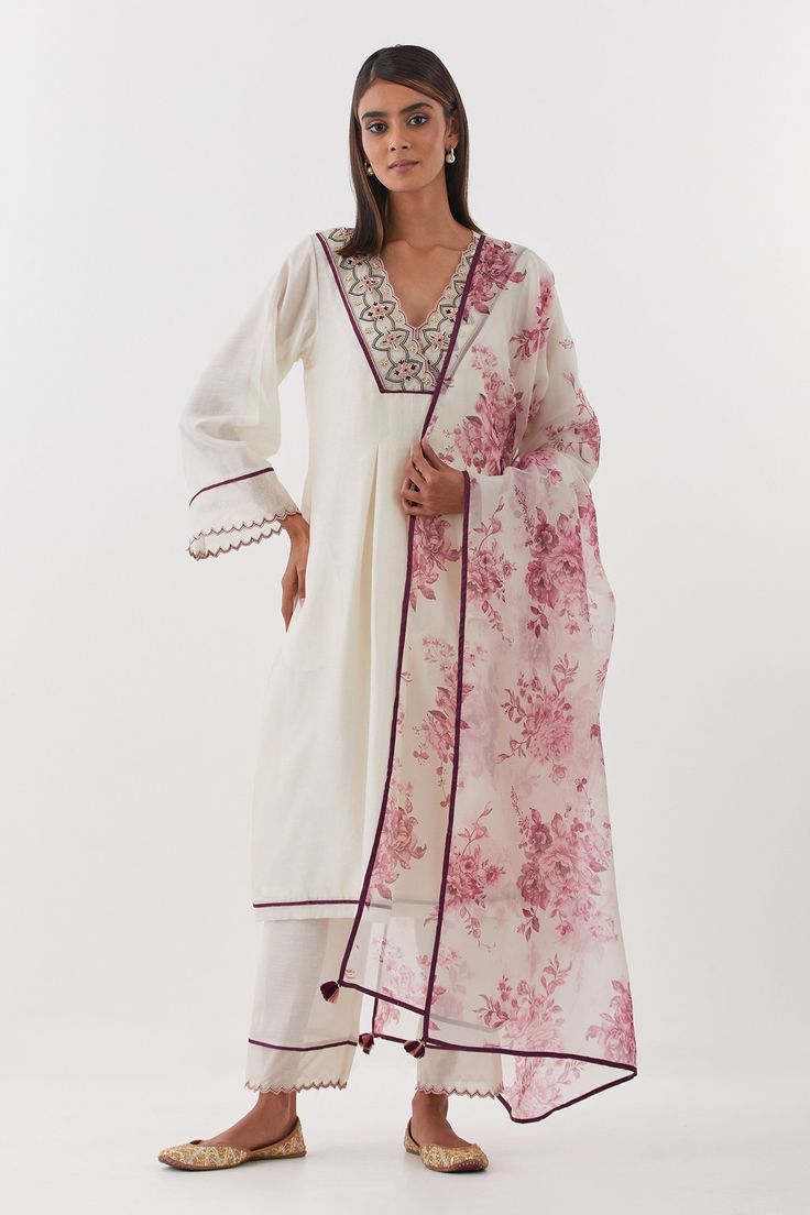 Ivory kurta featuring delicate zardozi embroidery on placket. Comes with scalloped hem pant, inner slip and floral print dupatta.
Components: 4
Pattern: Embroidered, Printed
Type Of Work: Floral, Zardozi
Neckline: V-neck
Sleeve Type: Three quarter
Fabric: Chanderi Silk, Silk Organza
Color: Ivory
Other Details: 
Scalloped embroidered borders
Tasselled dupatta
Box pleats on kurta
Occasion: Mehendi and Haldi - Aza Fashions Zardozi Embroidery, Kurta Set For Women, How To Hem Pants, Fashion App, Silk Organza, Embroidery Fashion, Kurta Set, Box Pleats, Scalloped Hem