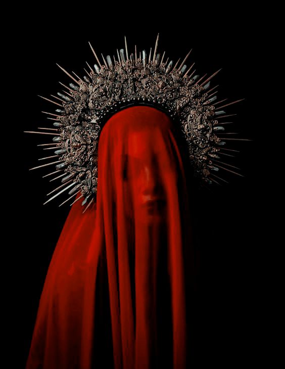 a woman with red veil and crown on her head