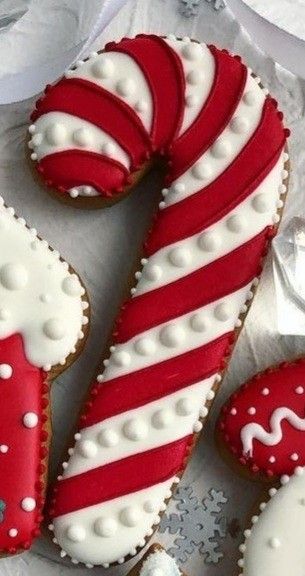 two decorated cookies are sitting on a table