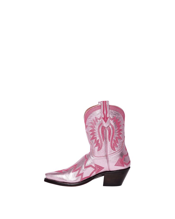 Maggie, our five-star darling, is the epitome of traditional western meets fashion. Elevated in playful metallic light pink, Maggie isn't just a cowboy boot; she's your go-to for every occasion. Her extra deep topline offers a super flattering silhouette that's endlessly versatile. Dress her up or dress her down—either way, Maggie promises to keep you looking fabulous from dawn till dusk. This boot is part of MC Personalization and can customize the Ear Pulls and/or add an interior Message Box. Pink Western Boots For Fall, Fitted Pink Boots, Pink Snip Toe Boots For Western-themed Events, Pink Western Snip Toe Boots, Pink Fitted Snip Toe Boots, Pink Western Boots With Snip Toe, Pink Western Boots For Rodeo, Fitted Western Pink Boots, Fitted Western Style Pink Boots