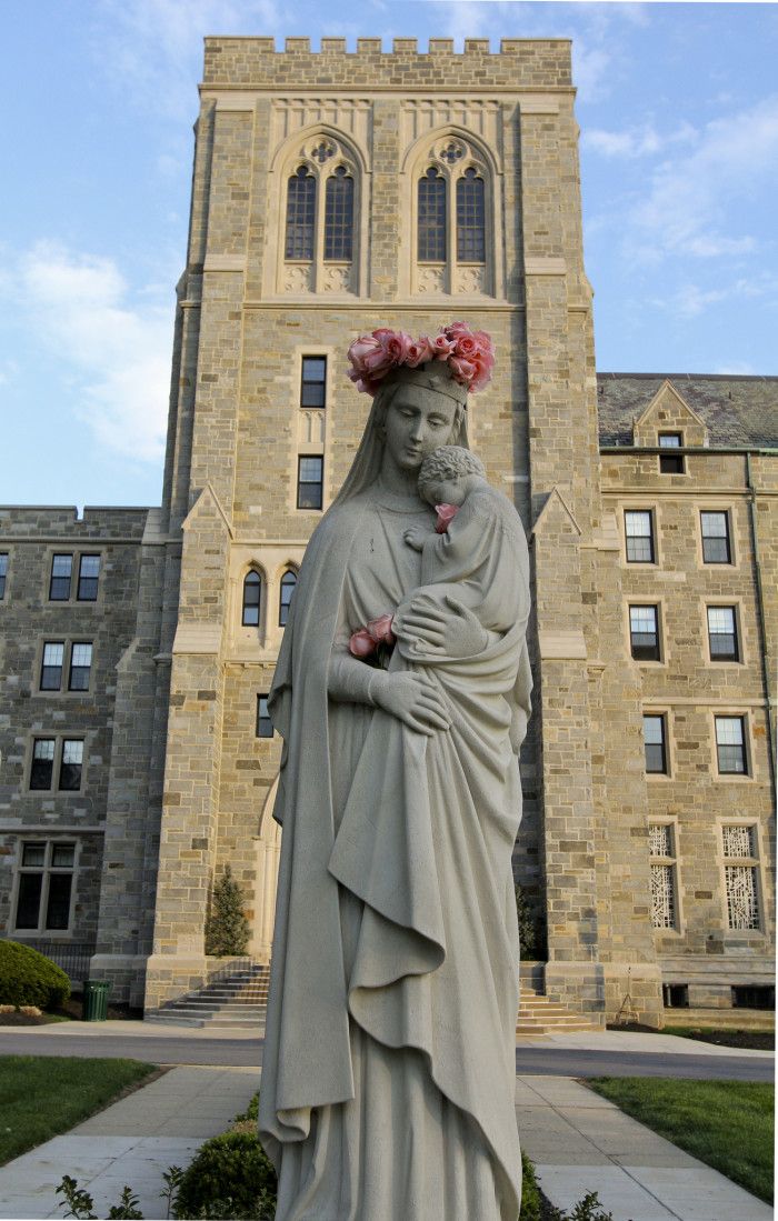 a statue in front of a large building