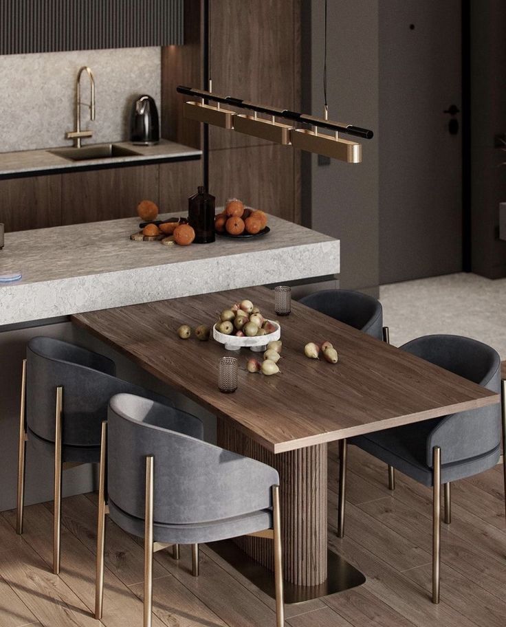 a kitchen with an island table surrounded by blue chairs