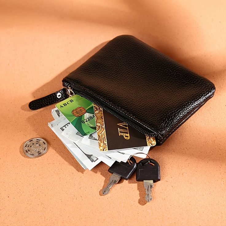 a wallet with keys and money sitting on top of it