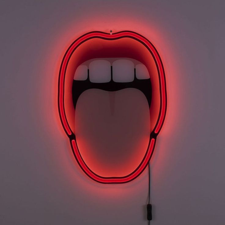 a neon sign with an open mouth on it's side in the shape of a tongue