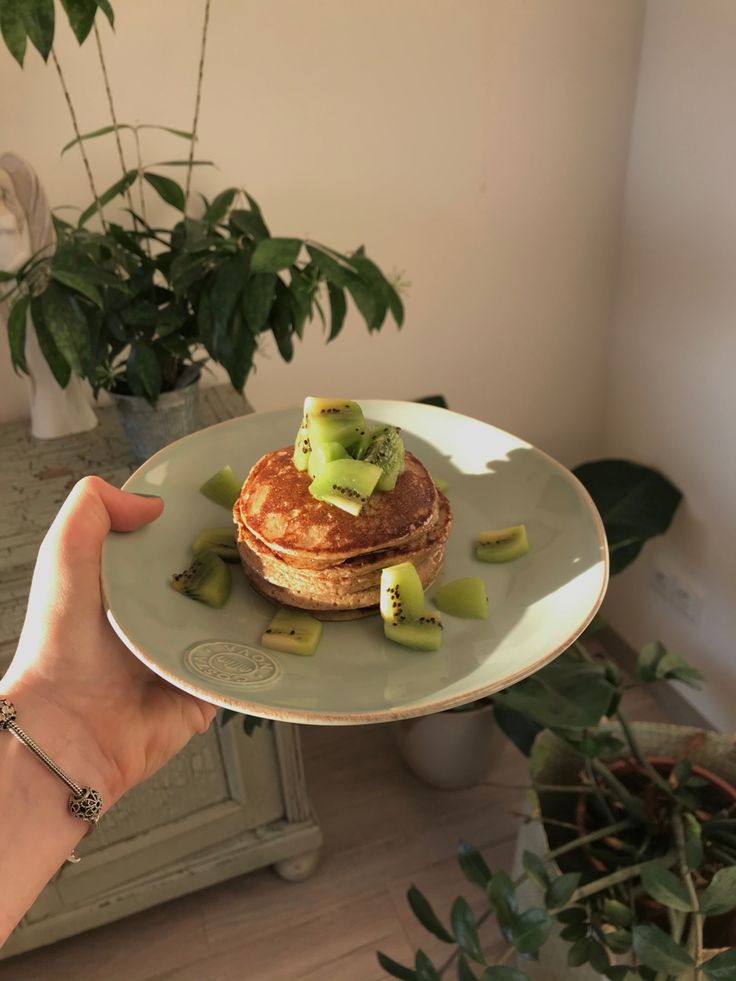 a person holding a plate with some food on it