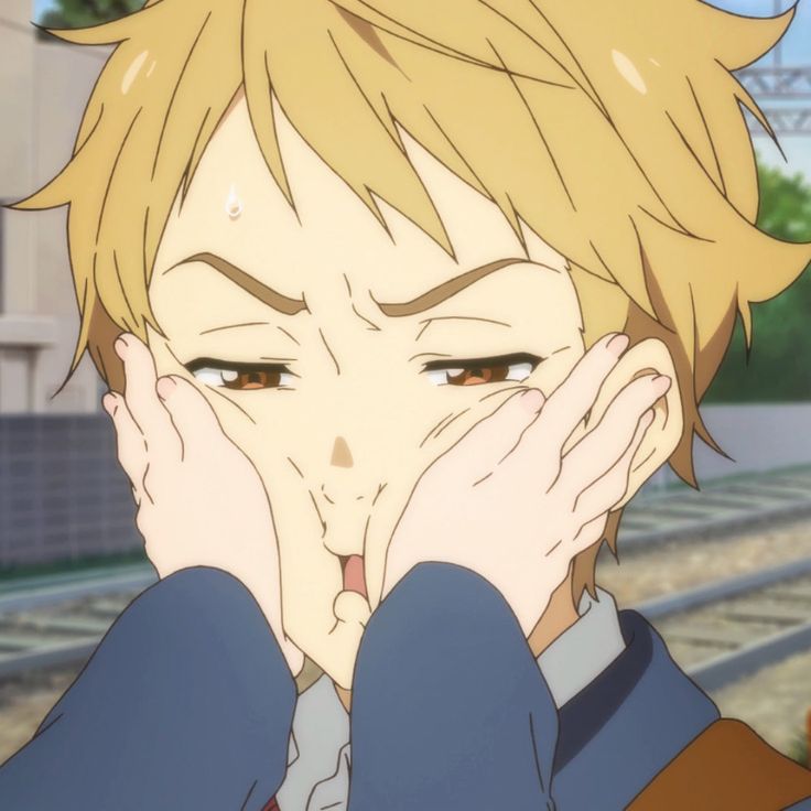 an anime character holding his hands to his face while standing in front of train tracks