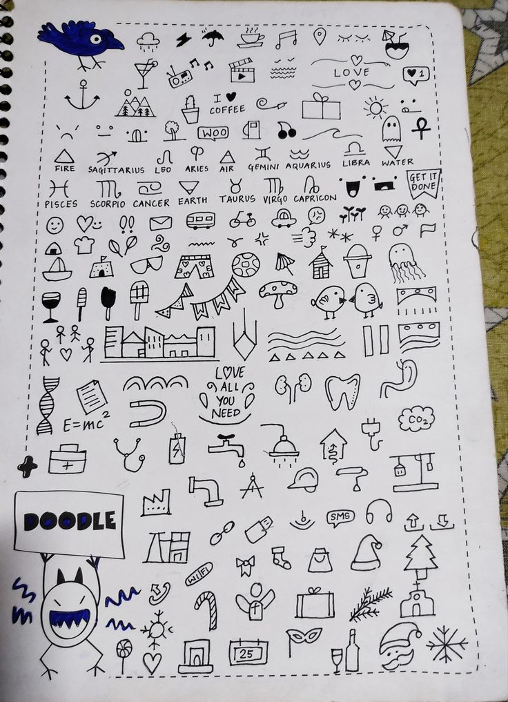 a notebook with doodles on it sitting on top of a table next to a pen