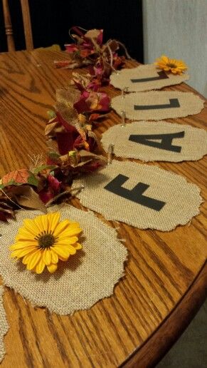 a wooden table topped with flowers and burlocks