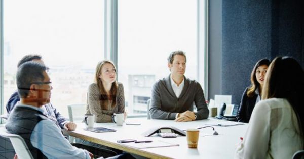 a group of people sitting around a conference table