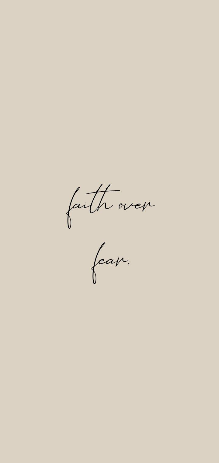 a black and white photo with the words faith over fear written in cursive writing