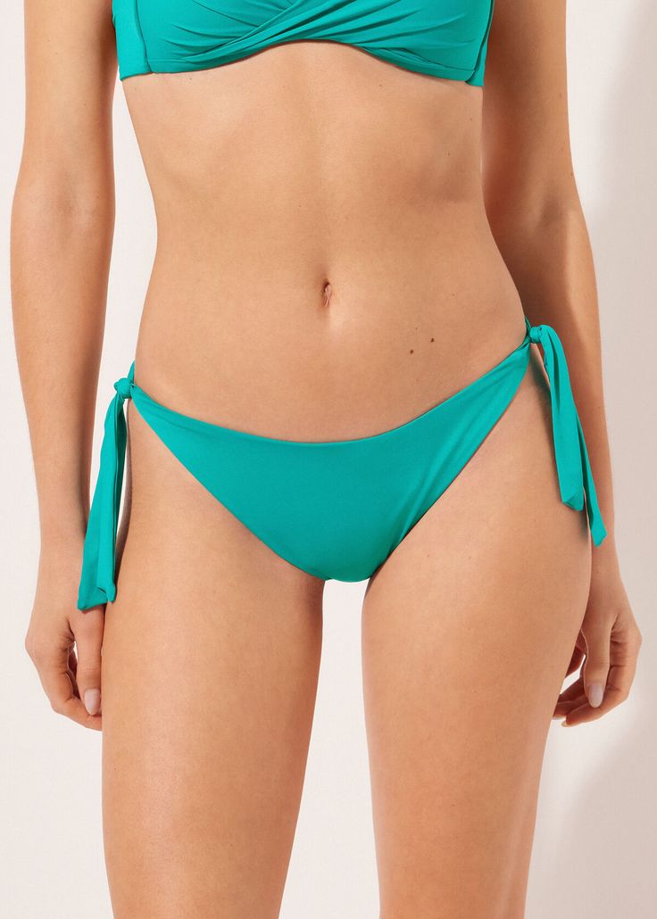 Tied Swimsuit Bottom Indonesia - Side tie - Calzedonia Tie-side Bottom Swimwear For Sunbathing, Tie-side Bottom Swimwear For Swimming, Tie-side Swimwear For Swimming, Fitted Tie-side Bottoms With Tie Back, Tie-side Bottom Swimwear For Pool, Green Swimwear With Side Ties For Pool, Stretch Bottoms With Side Ties For Pool, Tie-side Bottoms With Drawstring For Sunbathing, Beachwear Bottoms For Sunbathing With Tied Details