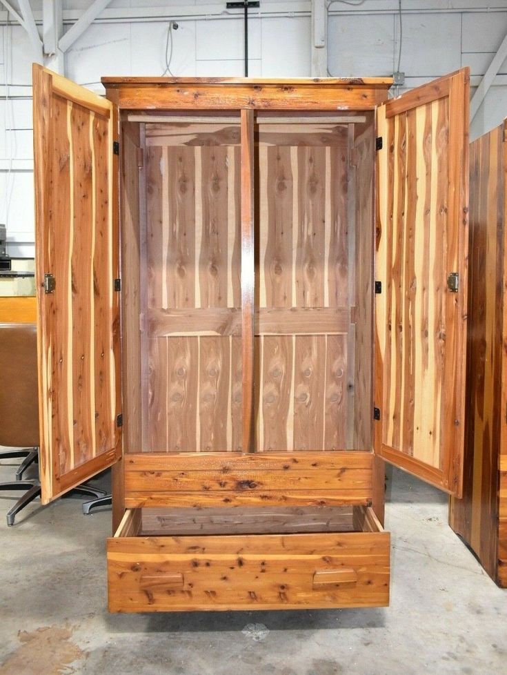 an open wooden cabinet sitting inside of a building