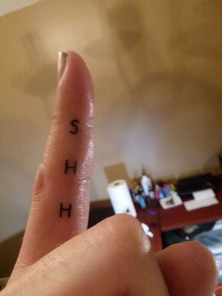 a person's finger with the word sushi written on it