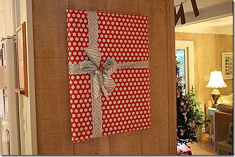 a red and white wrapped present hanging on the wall