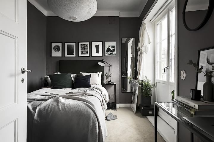 black and white bedroom with pictures on the wall