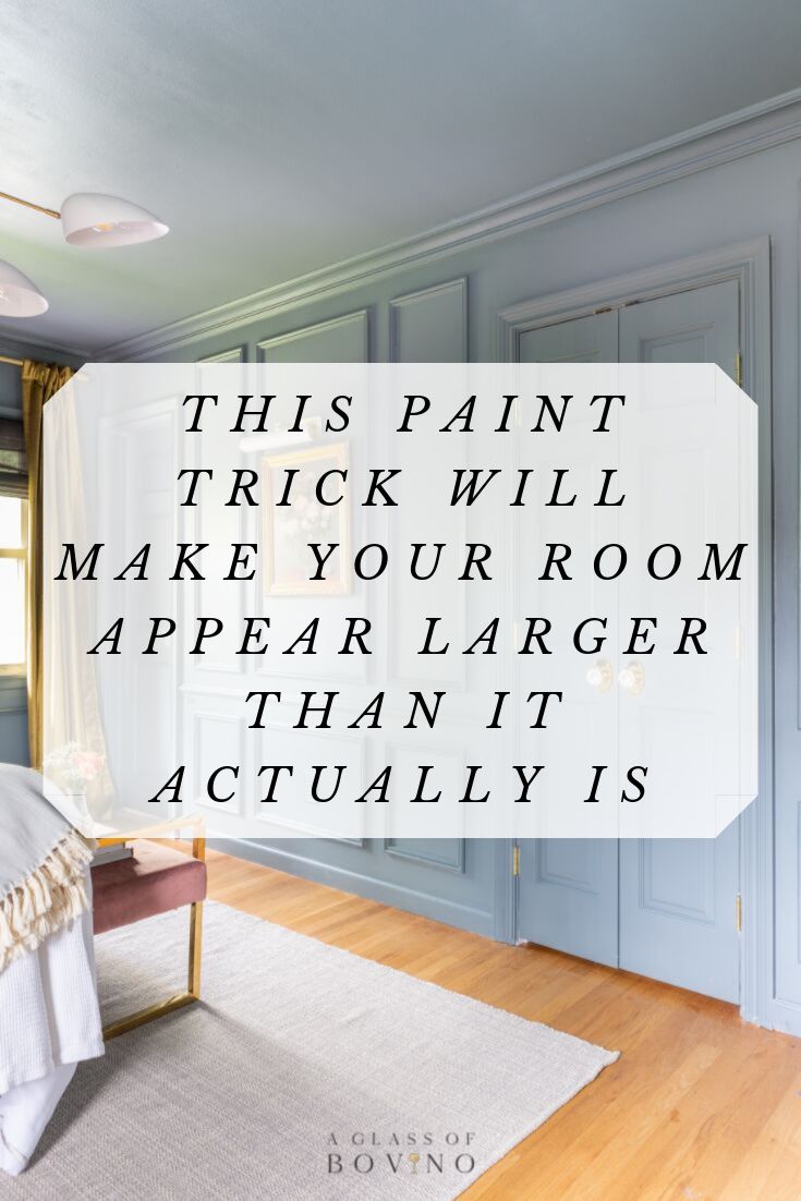 a bedroom with blue walls and wood floors, the words this paint trick will make your room appear larger than it actually is