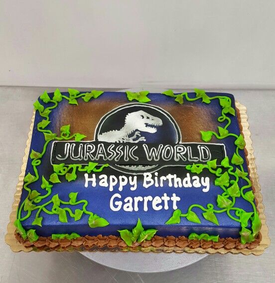 a blue and green birthday cake with the words happy birthday garrett on it