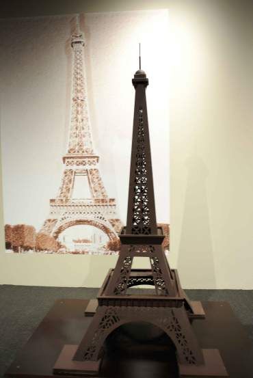 a model of the eiffel tower is shown in front of a wallpaper