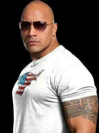 a bald man with sunglasses and an american flag t - shirt is looking at the camera