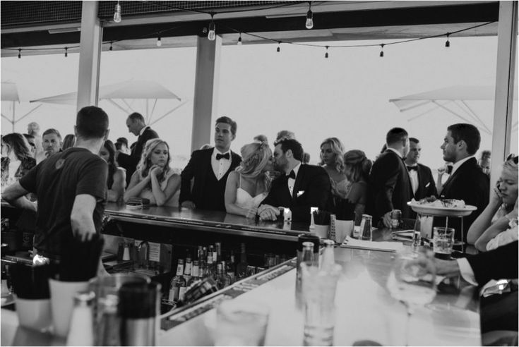 a group of people sitting at a bar