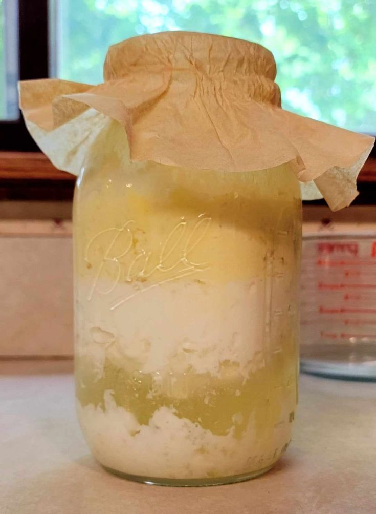 a jar filled with liquid sitting on top of a counter