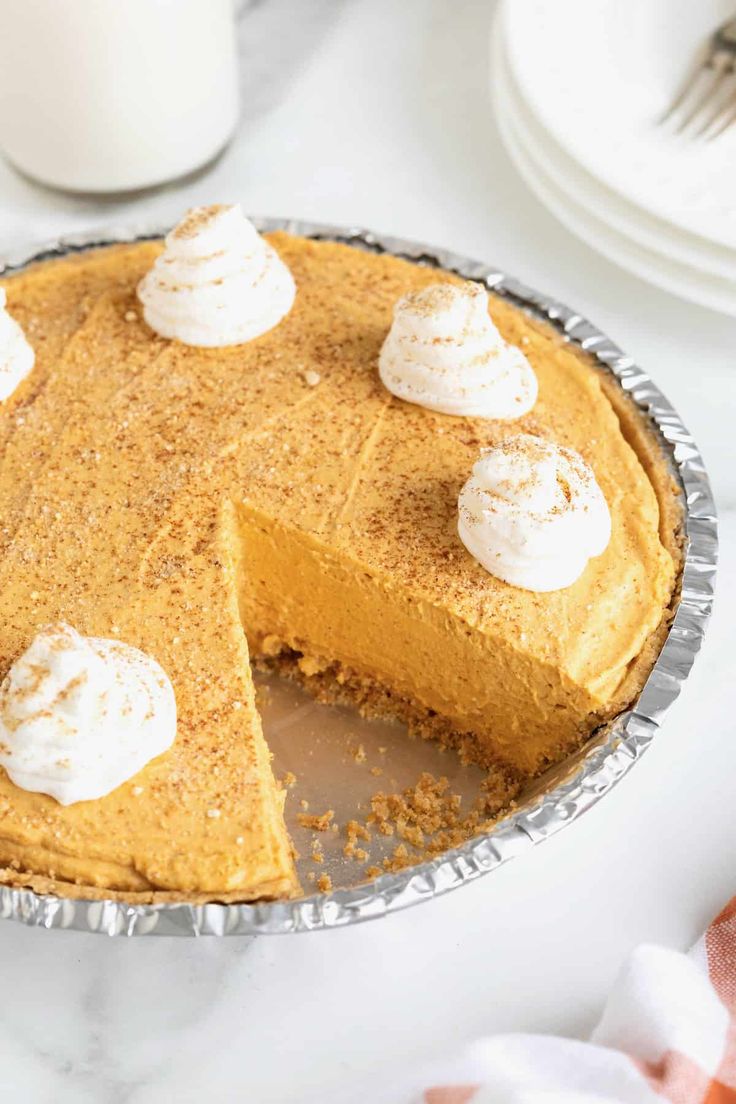 a pumpkin pie with one slice missing from it