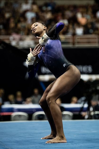 a woman standing on top of a blue floor