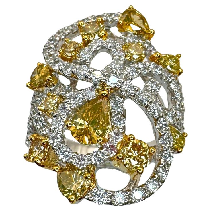 Elevate your style with our 18k Yellow and White Diamond Ring. Weighing 7.2 grams and sized at 6.5, it features stunning 1.76 carats of yellow diamonds and gracefully complemented by 1.45 carats of white diamonds. A timeless blend of sophistication and brilliance. 18k Yellow and White Diamond Ring Condition: In good condition with some minor surface wear consistent with age. Ring size: 6.5 Markings: "750" "T864" Metal: 18k White Gold Weight: 7.2 grams White Diamonds: 1.45 carats Yellow Diamonds: 1.76 carats Clear Sunglasses Frames, Yellow Diamonds, White Diamond Ring, Yellow Diamond, White Diamonds, Elevate Your Style, Cocktail Rings, White Diamond, Diamond White