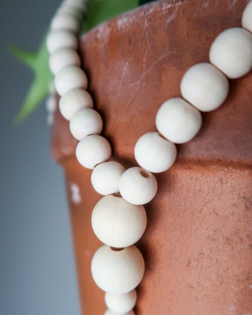 a close up of a cake with white beads on it