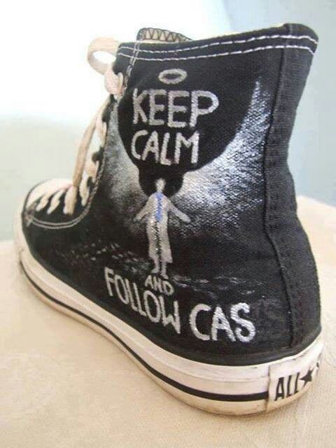 a pair of black shoes with the words keep calm and follow gas painted on them