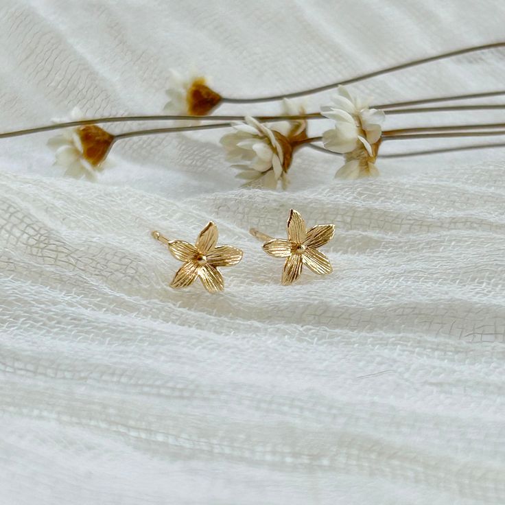 Our dainty gold flower studs are a favorite for everyday wear and one of our bestsellers. A simple, feminine addition to any outfit. 14K gold plated. Size: 8mm THE DETAILS -Earrings include soft rubber backings -Shipped via USPS with tracking Dainty Flower Earrings With 3d Flowers, Gold Delicate Flower Earrings, Delicate Gold Flower Earrings, Gold Birth Flower Shaped Earrings, Delicate Gold Birth Flower Earrings, Everyday Gold Flower Charm Earrings, Gold Feminine Flower Earrings With 3d Flowers, Dainty Gold Flower Charm Earrings, Gold Petal Flower Earrings For Gifts