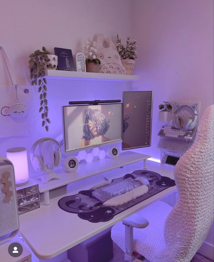 a white desk topped with a computer monitor next to a purple chair and other items