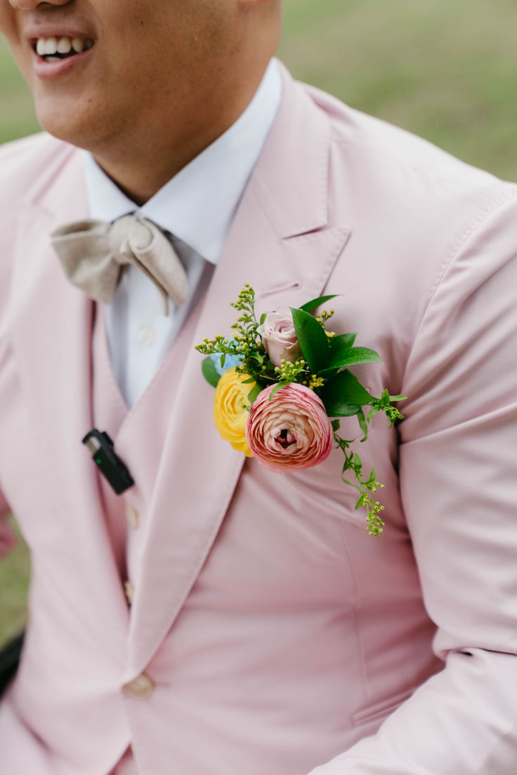 Vibrant pastel groom boutonniere tucked into a suit pocket for a unique and stylish wedding accessory. Perfect for adding color to the groom's look. Pastel Boutonniere, Pocket Square Boutonniere, Square Boutonniere, Pastels Palette, Pocket Boutonniere, Blue Delphinium, Flowers Real, Rainbow Wedding, Groom Looks