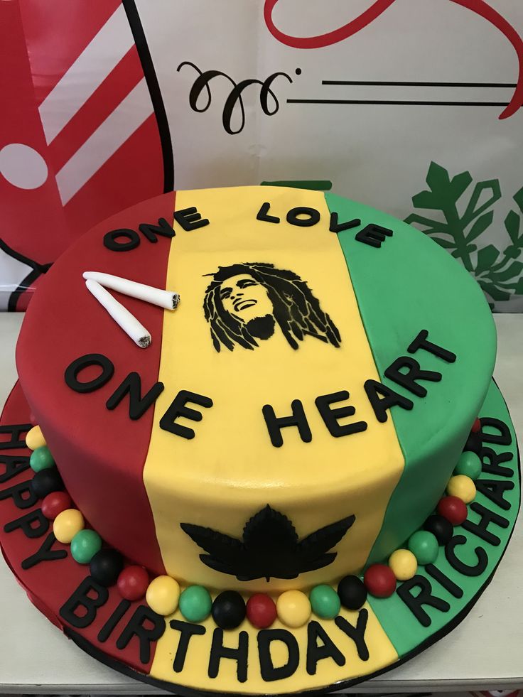 a birthday cake decorated with the colors of reggae