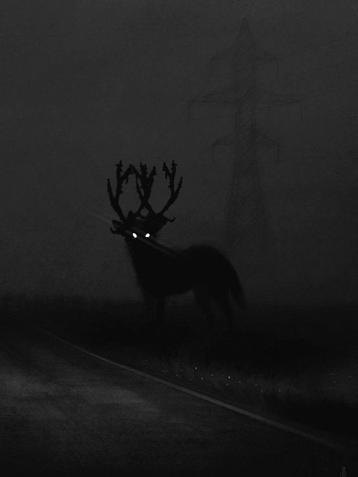 a black and white photo of a deer with glowing eyes in the dark night sky