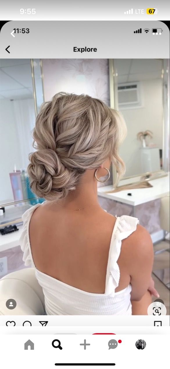 the back of a woman's head, with her hair in a low bun