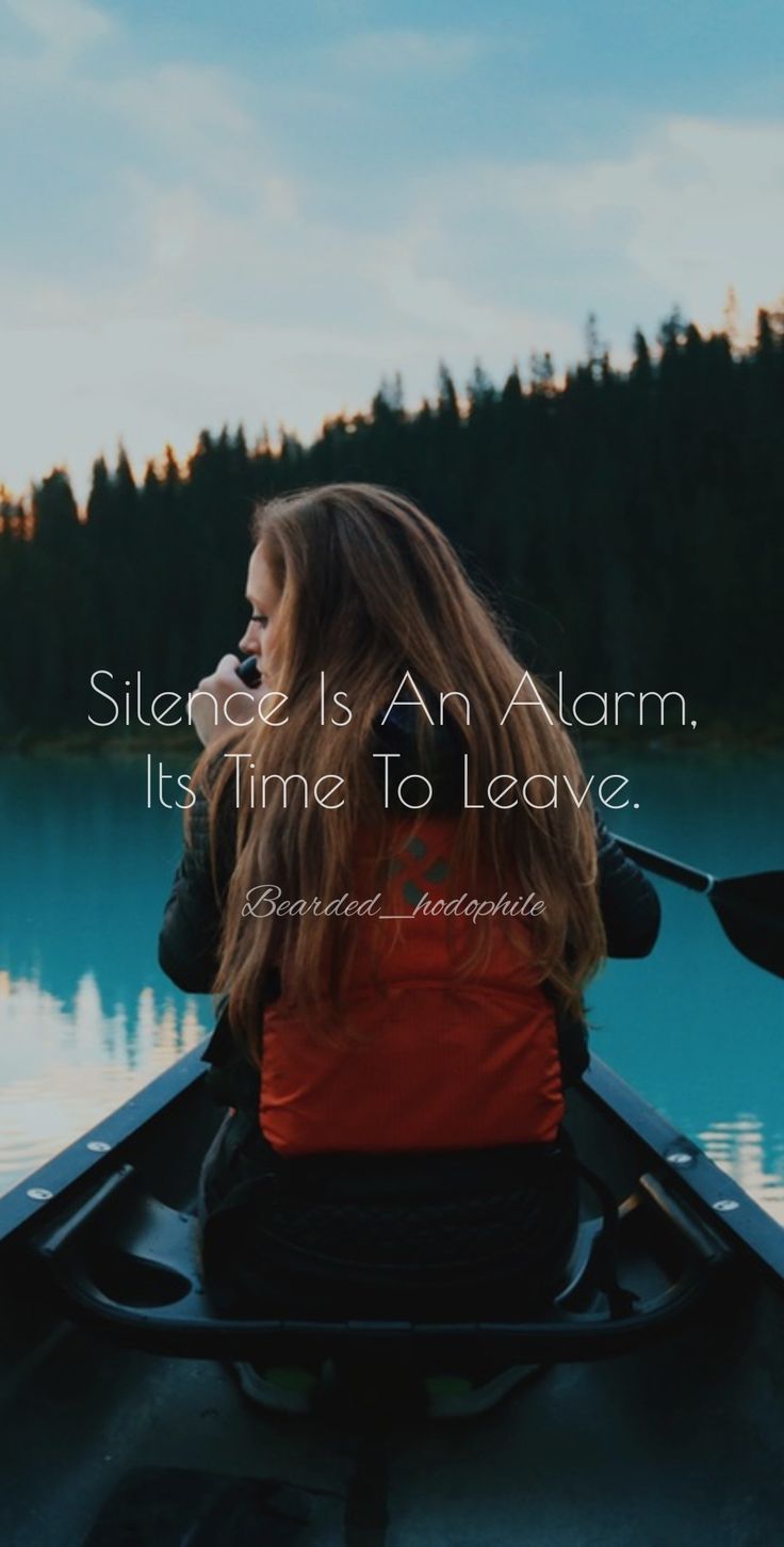 a woman is sitting in a canoe on the water