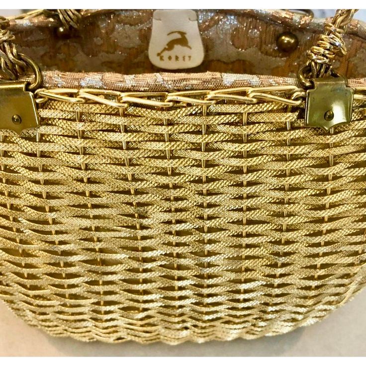 1950s to 1960s basketweave metal purse by Koret. Beautiful gold tone purse with metallic brocade lining and a gold leather change purse attached. Gold wire handles. Luxury Gold Woven Bag, Gold Woven Clutch Bag, Retro Gold Bags With Gold-tone Hardware, Gold Retro Bags With Gold-tone Hardware, Gold Retro Bags, Chic Gold Evening Bag With Handles, Gold Bucket Bag For Formal Occasions, Luxury Gold Bucket Evening Bag, Elegant Gold Bucket Evening Bag