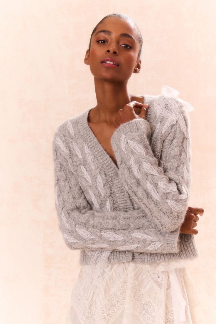 Loving on the Louella Cardigan. This cozy chic cardigan is designed from a soft alpaca blend wool. She features delicate lace ribbon cables woven throughout for a playful look. With a shorter body and straight sleeves, this knit stuns with a modern yet flattering fit. The piece is complete with our custom LoveShackFancy faux shell buttons down center front.