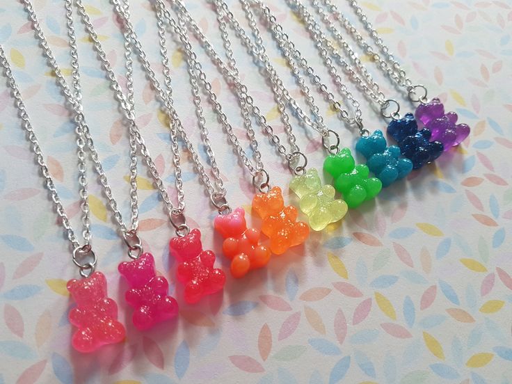 "relieve some sweet childhood memories or just show off your sweet tooth with this cute gummy bear necklace! made using a flatback neon glitter resin pendant hung from silver plated chain. total length of chain measures approx. 16\" and fastens with a lobster clasp fastener. bear measures approx. 17mm x 11mm. * available in green, bright blue, hot pink, pink/orange, orange, yellow, pink, bright pink, royal blue and purple *" Cute Gummy Bear, Gummy Bear Necklace, Baby Disney Characters, Retro Neon, Rave Accessories, Bear Bear, Sweet Necklace, Rose Orange, Bear Pendant