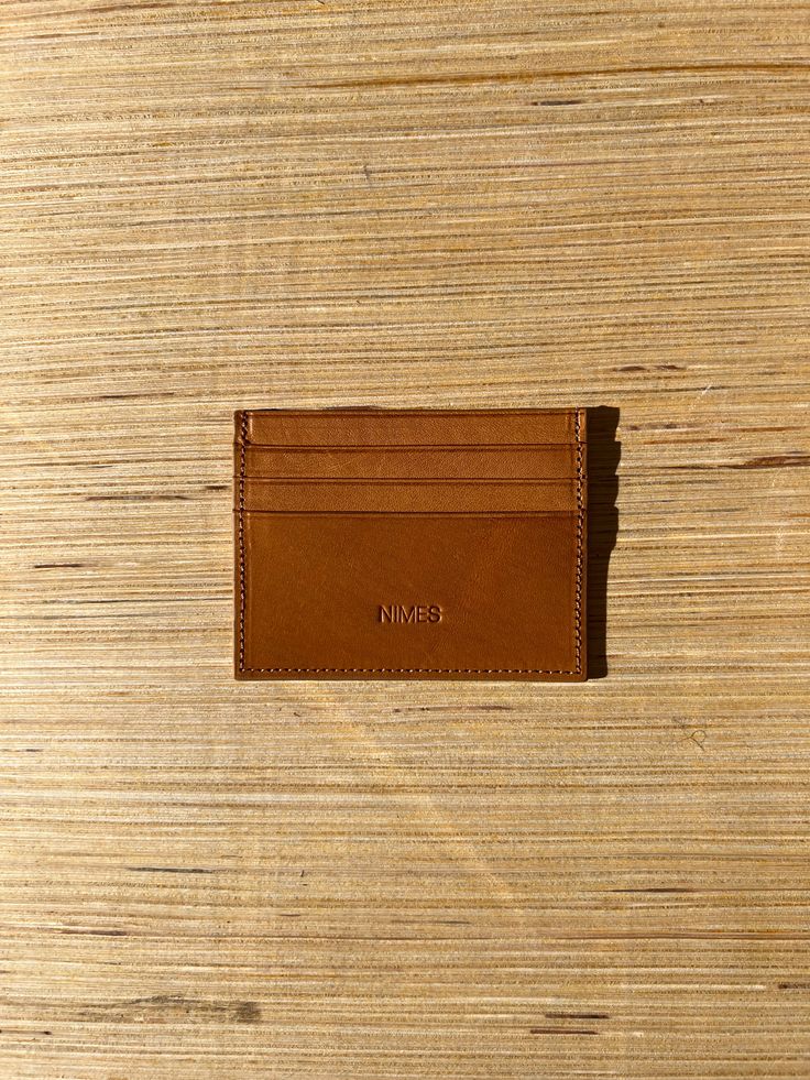 Sleek and simple, this leather card holder is an easy way to elevate your lifestyle. Hand made using vegetable tanned natural smooth navy leather, it has one internal pocket and 3 credit card slots on each side, and is lined with printed fabric. Height: 3.4" Width: 4.5" Depth: 0.4" Made in Argentina Leather Card Holder With Card Slots For Everyday, Everyday Leather Card Holder With Card Slots, Casual Bifold Leather Card Holder, Casual Leather Card Holder, Casual Leather Card Holder With Card Slots, Casual Leather Card Holder With Interior Slots, Casual Leather Card Holder With Slots, Casual Leather Rectangular Card Holder, Casual Business Card Holder With Interior Slots