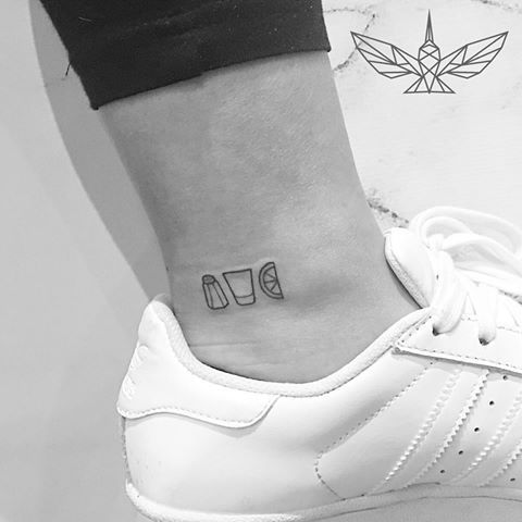 a woman's foot with a small tattoo on her left ankle and the word love