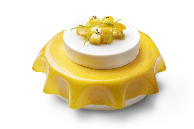 a yellow and white plate with some food on it's top, in the shape of a flower