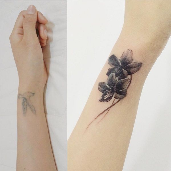 two different tattoos with flowers on their arm and wrist, one is black and the other is white