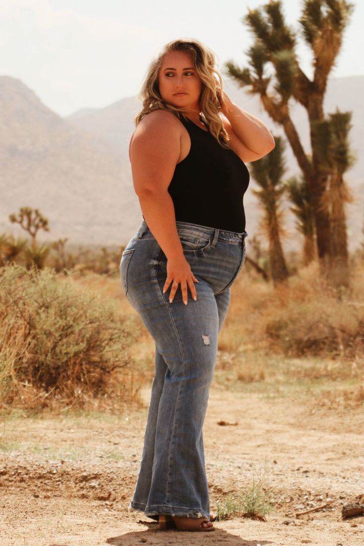 Details High rise 32" inseam Distressed knee Comfy and stretchy Care 88% Cotton 10% Rayon 2% Spandex Model's Measurements Height: 5'4", Inseam: 29.5", Hips: 55", Waist: 45", Bust: 48" Model wearing a size 16 Photoshoot Plus Size Photography Poses, Western Style Plus Size, Poses For Curvy Women, Plus Size Cowgirl Outfits, Plus Size Photoshoot, Plus Size Western Wear, Plus Size Cowgirl, Female Plus Size, Plus Size Posing