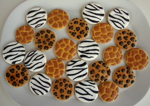 cookies decorated with zebra print and leopard prints on a plate