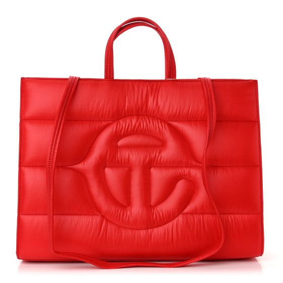 This is an authentic TELFAR Nylon Large Puff Shopping Bag in Red.This is a tote crafted of nylon in black with the iconic Telfar logo stitched on the front. The shoulder bag has short top handles, and two long shoulder straps. The top secures with a magnet snap and opens toa red fabric lined interior with zipper and patch pockets. Red Nylon Shopping Bag, Designer Nylon Bags For Shopping, Red Rectangular Nylon Shoulder Bag, Telfar Logo, Pool Bags, Red Fabric, Short Tops, Patch Pocket, Shoulder Straps